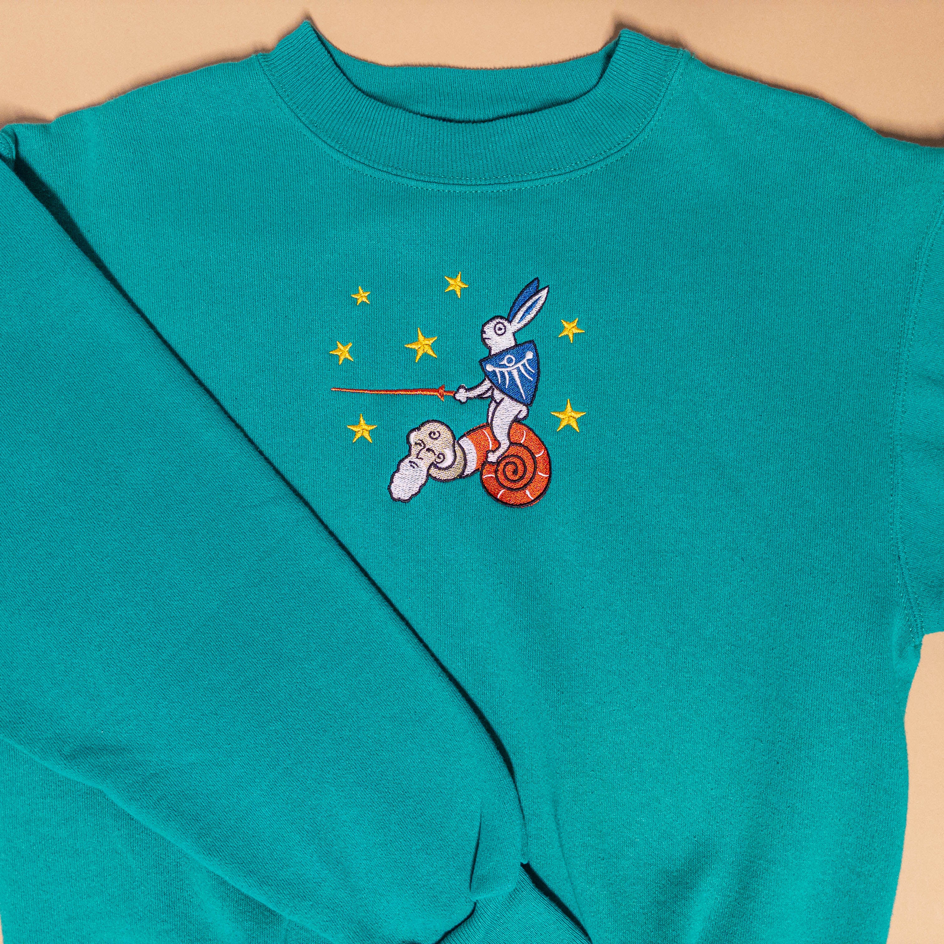 Medieval Rabbit Riding Snail With Stars Sweater in Teal